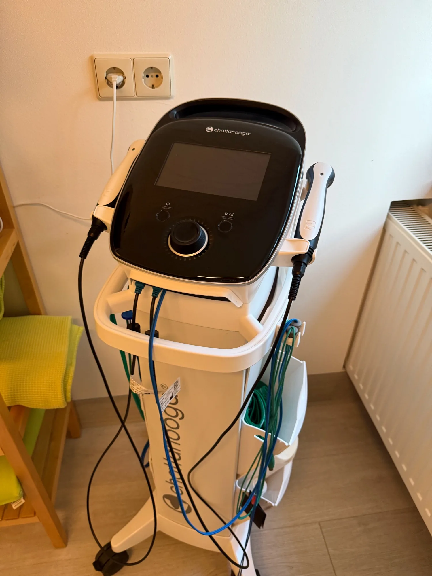Fahrbares Ultraschall- und Elektrotherapiegerät mit zwei Schallköpfen im Behandlungsraum